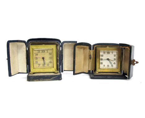 A Zenith Gilt Metal Travelling Clock, of square form, bun feet, leather case, 5.5cm high; Another, similar. (2)clocks unteste