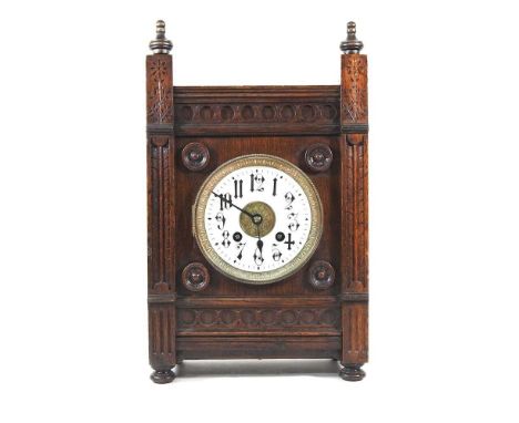 An early 20th century oak cased bracket clock, with an enamel dial