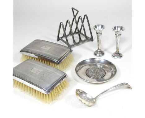 A pir of mid 20th century silver backed brushes, together with a silver dish, a sifting spoon, a pair of spill vases and a si
