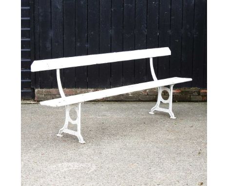 A white painted wooden garden bench, on metal supports, 216cm wide