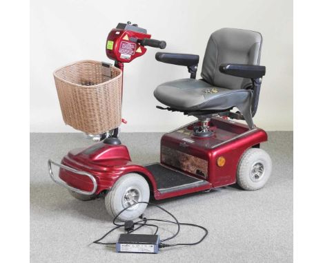 A red Shoprider electric mobility scooter, with charger