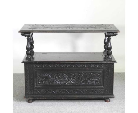 An early 20th century carved oak monk's bench, with a hinged top102w x 48d x 81h cm