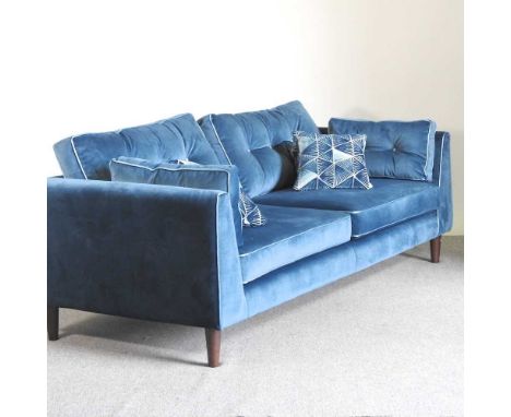 A Sofology blue velvet upholstered sofa, with a button back, on turned legs, with loose cushions224w x 97d x 70h cmOveral con