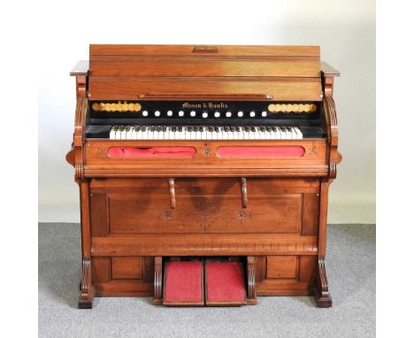 A Victorian walnut cased chapel organ, by Mason &amp; Hamlin, with medallions for commissions awarded throughout Europe in th
