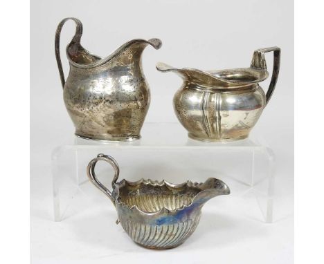 A George III silver cream jug, London 1803, 107g, 10cm high, together with an early 20th century silver cream jug, 185g and a