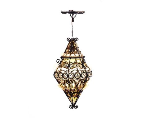 VINTAGE WROUGHT IRON AND AMBER CEILING LIGHT.HEIGHT: 15 INCHES.DIAMETER: 8½ INCHES. IN GOOD CONDITION.