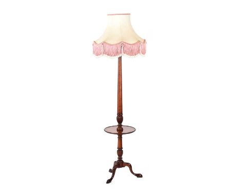 MAHOGANY TURNED STANDARD LAMP AND SHADE WITH FITTED SHELF TO CENTRE ON THREE SPLAYED LEGS.HEIGHT: 74 INCHES.DIAMETER OF SHELF