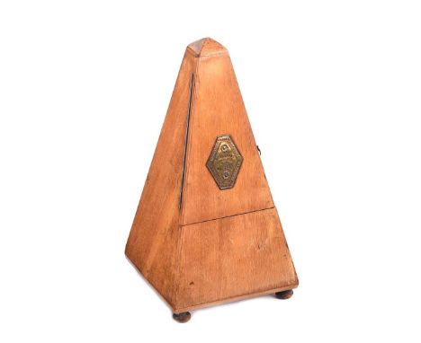 METRONOME WITH BRASS PLAQUE TO FRONT.HOLLANDE ANGLETERRE PARIS FRANCE. RAISED ON TWO BUN FEET.HEIGHT: 9 INCHES.IN GOOD CONDIT