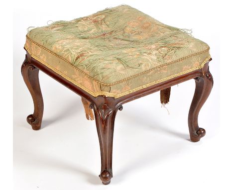 A 19th Century French style mahogany square-shaped stool, the seat upholstered in worn tapestry, raised on leaf carved scroll