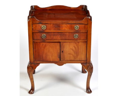 A mahogany tray top commode, the rectangular top with shaped gallery and cut-out handles, fitted two drawers below and a pair