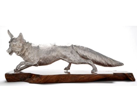 An Elizabeth II large model of a fox, resting on a wooden base, by C. J. Vander, London, 1974, 19in. (48.5cms) 68.7oz. 
See i