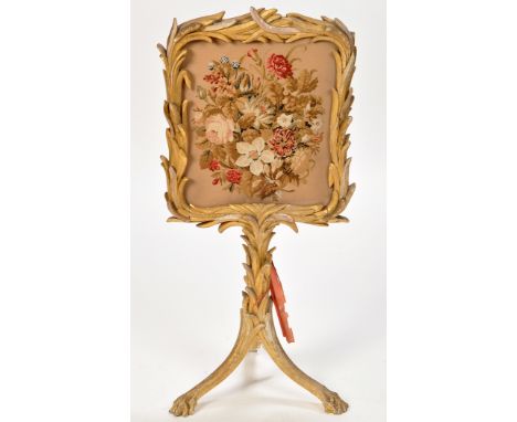 A 19th Century giltwood firescreen, with floral woolwork tapestry within carved bull rush decorated frame and stand, raised o