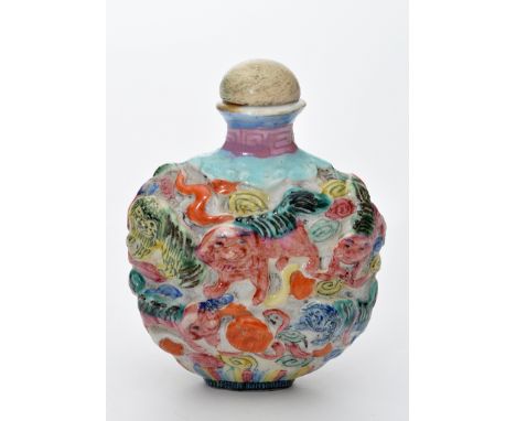 Chinese Famille Rose snuff bottle, of disc form with foo dogs in high relief, height 7cms, four character Qianlong seal mark 