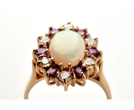 An opal, ruby and diamond ring, the oval opal surrounded by six diamonds and six rubies, cage mount on 9ct. yellow gold shank