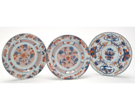 Three Chinese Imari dishes, comprising: pair with floral bursts enclosed by lattice and panel border, diameter 22.5cms; dish 