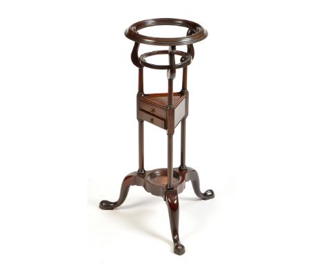 A George III basin stand, the moulded rim raised on shaped turned supports, triform undertier fitted two small drawers, the b
