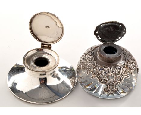 An Edwardian silver mounted glass inkwell, by William Comyns, London 1903, 3in. (8cms); and an Edwardian capstan form silver 