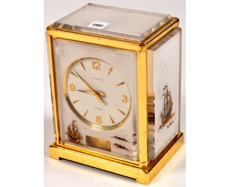 Jaeger LeCoultre: a Marina 'Atmos' clock, the white dial with arrow pattern numerals and arabic quarters, the opaque perspex 