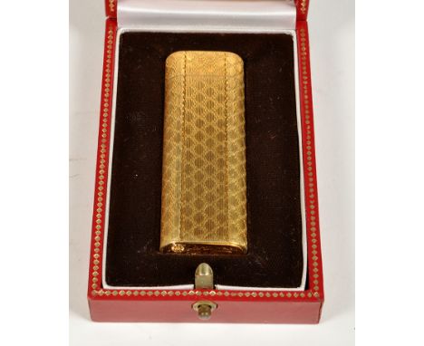 Cartier, Paris: a gold plated cigarette lighter, with engine turned design, numbered 27408S, red leather case.
