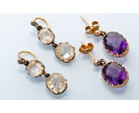 A pair of amethyst drop earrings, each oval facet cut amethyst within cut down collet setting, on a post and butterfly mount;