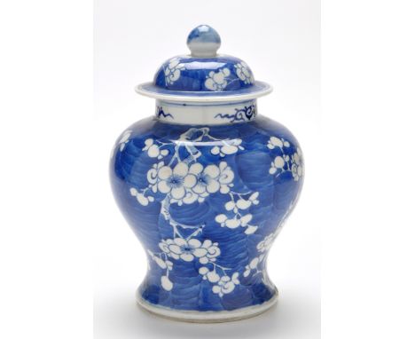 Chinese blue and white inverted baluster vase and cover, blue ground with prunus blossom, height 27cms, four character Kangxi