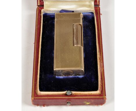 A mid 20th Century 9ct. gold cigarette lighter by Dunhill, with engine turned decoration, in a Dunhill case.