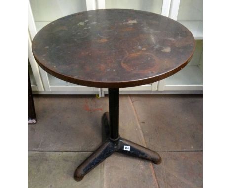 A copper top pub/industrial style table on painted metallic tripod supports