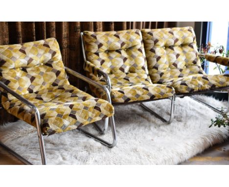 A 1970s stylish chrome two seater sofa and matching armchair in geometric velvet upholstery