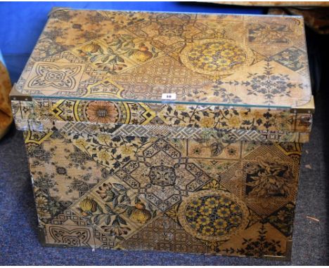 A vintage Japanese tea chest covered in decorative floral and geometric design paper