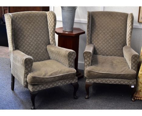A pair of vintage wing back chairs