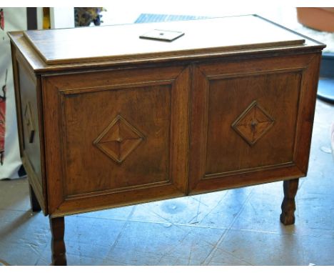 An unusual panelled oak blanket chest raised on four corner supports and with raised diamond decoration to each panel and wit