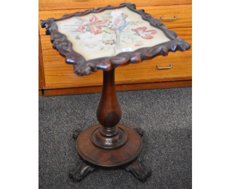 A Victorian rosewood pole screen/table on a circular base with four scroll supports and having a tapestry panel insert with p