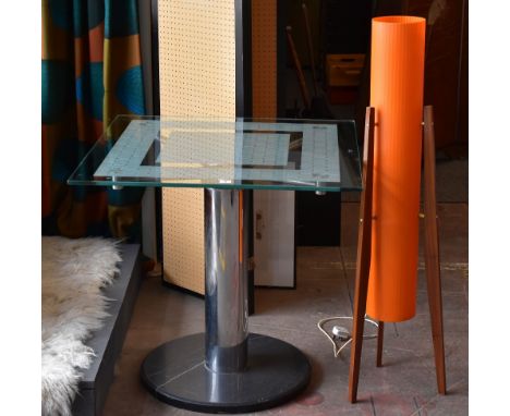 A modern glass topped table with chrome supports and marble base together with a retro space age style standard lamp