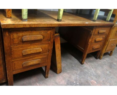 A larger vintage oak kneehole office desk with two flanks of three drawers