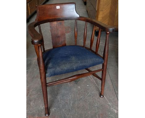 A vintage captain style elbow chair with padded and upholstered seat