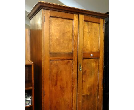 A two door pitch pine chapel closet with metallic handle and internal clothes rails and shelf