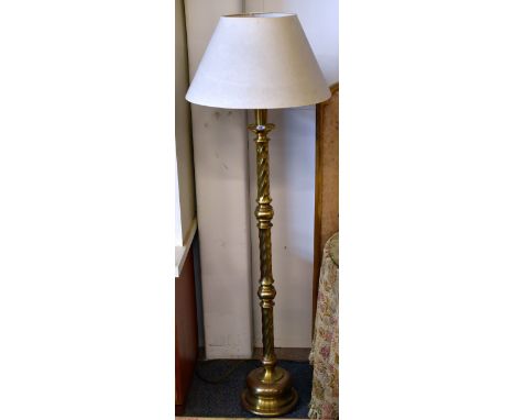 A brass/brassed twist column circular based standard lamp and shade