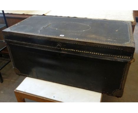 A vintage studded cabin trunk with floral painted interior circa 1890-1900