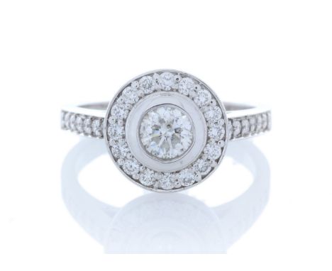 A sparkling natural round brilliant cut diamond 0.50 carats is surrounded by a halo of sixteen round brilliant cut diamonds w