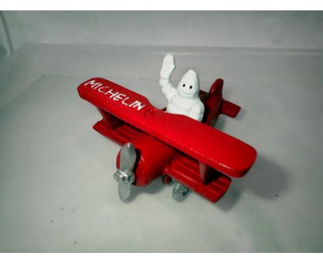 Cast iron Michelin Man in a plane, H: 80 mm. UK P&amp;P Group 1 (£16+VAT for the first lot and £2+VAT for subsequent lots) 