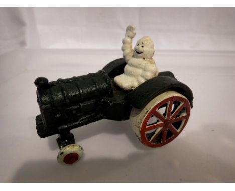 Cast iron Michelin Man on a tractor, H: 80 mm. UK P&amp;P Group 1 (£16+VAT for the first lot and £2+VAT for subsequent lots) 