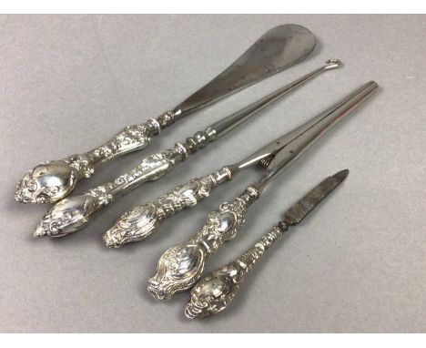 SILVER MOUNTED SHOE HORN, along with a button hook, nail file and glove stretchers, each of Rococo design (4)