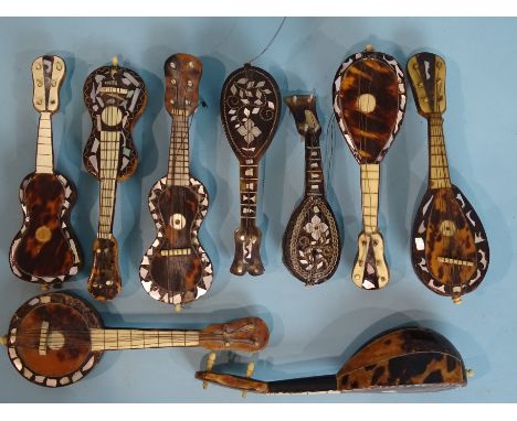 A collection of nine late-19th century tortoiseshell and mother-of-pearl miniature musical instruments, comprising five lutes