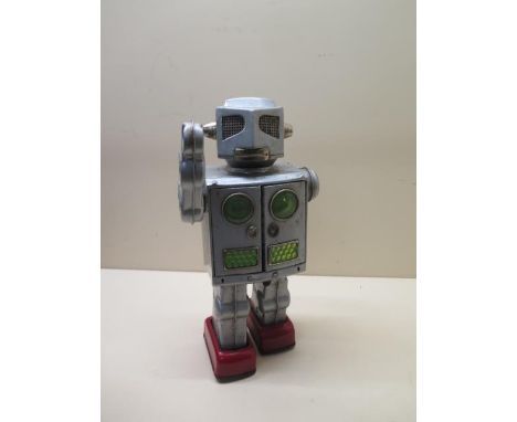 A battery operated Japanese tinplate robot with opening chest with two lasers, working order, only one laser working, some sc