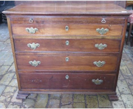 A Georgian and later mahogany bachelors chest with a brushing slide above four graduating drawers on shaped bracket feet, in 