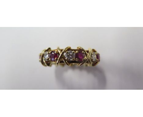 An 18ct yellow gold ruby and diamond full eternity ring with 8 x 0.13ct VVS1/G-H brilliant cut diamonds and 8 x Burma rubies,