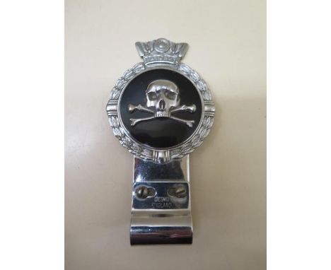 A Desmo skull and crossbones car badge, 15cm tall, in good condition 