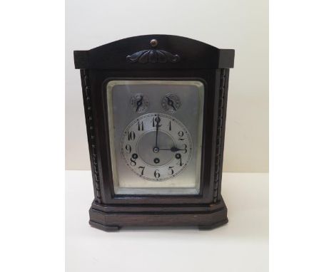 A Junghams oak chiming mantle clock with silver dial, 35cm tall, in working order, case good 