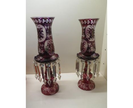 A pair of ruby glass candle lustres, 45cm high, converted to electric, one long drop missing, generally good, some small chip