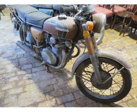 A Honda 250cc 1972 vintage motorcycle reg JOT 131L, in need of restoration with vehicle registration documents, manual, key, 